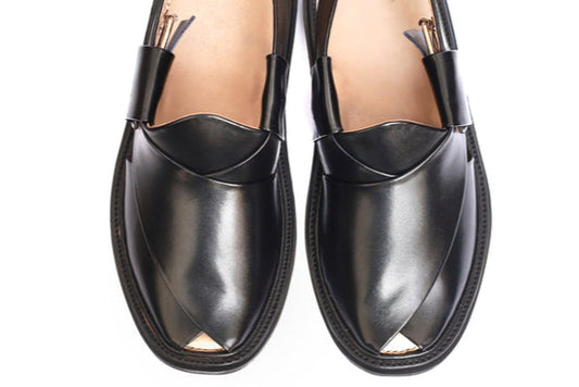 Pair of black loafers on a white background