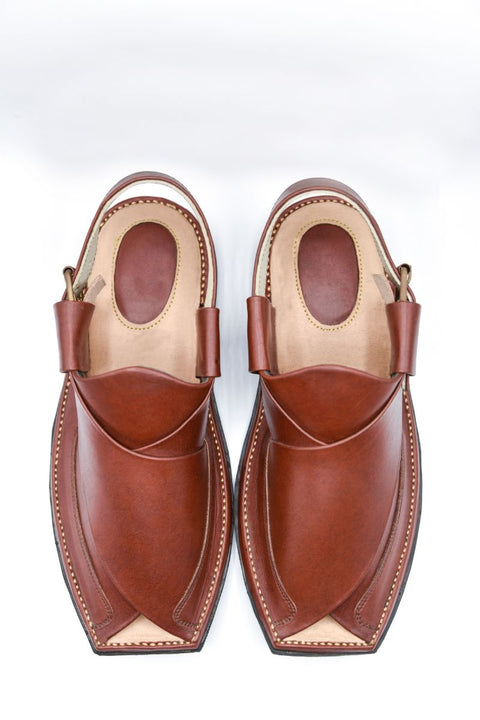 Pair of brown leather sandals on a white background