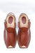 Pair of brown leather sandals on a white background