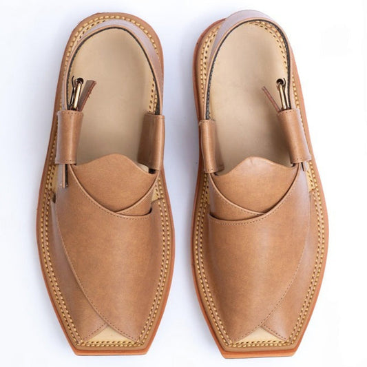 Pair of tan loafers on a white background